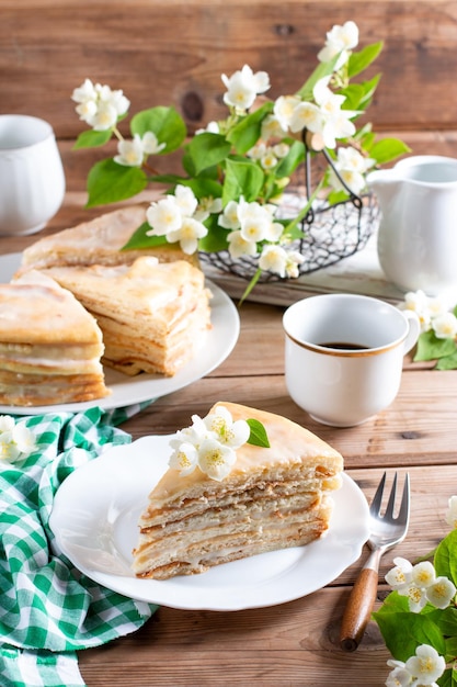 Homemade naked layered vanilla cake with whipped cream on a wooden table