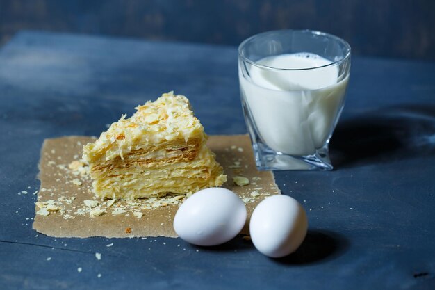 Homemade Napoleon cake with cream on a gray background