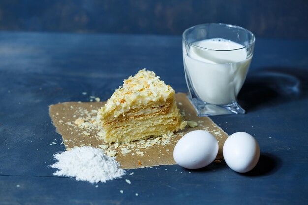 Homemade Napoleon cake with cream on a gray background