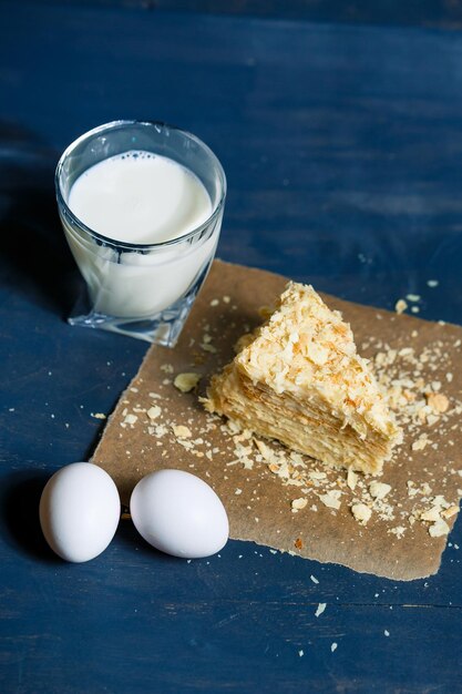 Homemade Napoleon cake with cream on a gray background