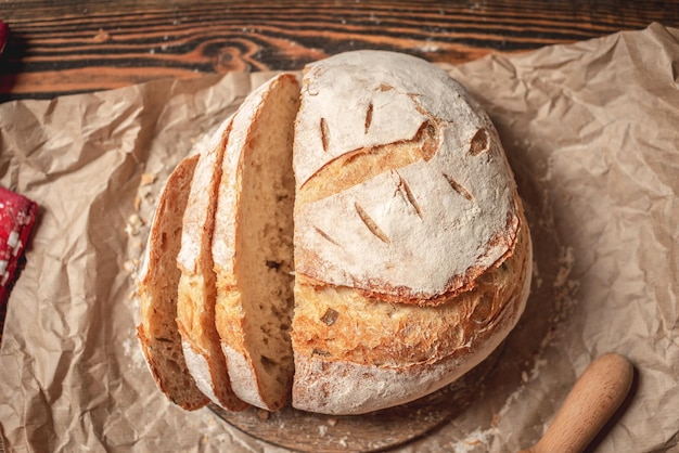 Homemade natural bread with a Golden crust on a napkin on an old wooden background Baking bakery products Rustic style