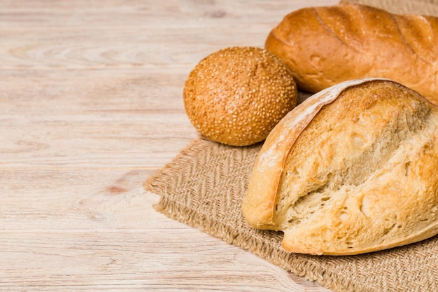 Homemade natural breads Different kinds of fresh bread as background perspective view with copy space