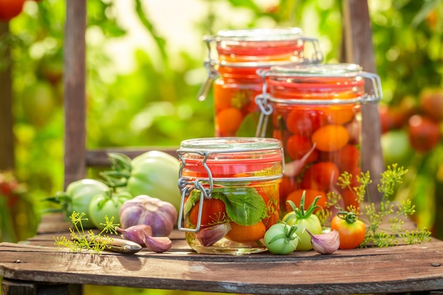 Homemade and natural pickled tomatoes with vegetables from greenhouse