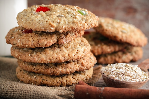 Homemade oatmeal cookies and oat flakes in wooden spoon