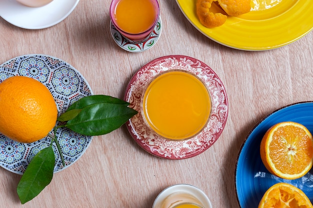 Homemade orange juice from above on wooden table