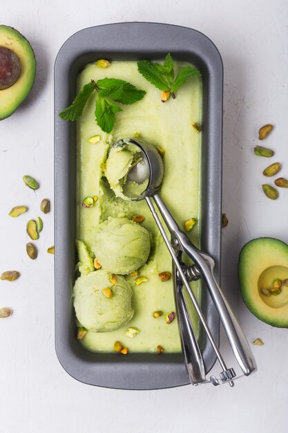 Homemade organic avocado and mint ice cream in a metallic container