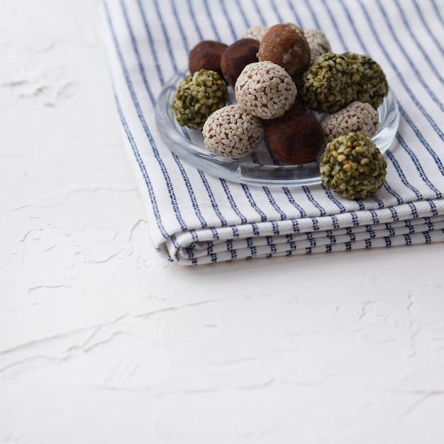 Photo homemade organic healthy raw energy sweet balls on a plate with a napkin.