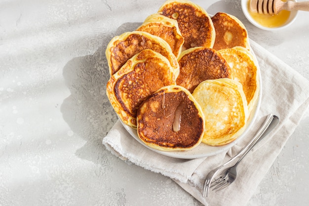 Homemade pancakes with honey and sour cream