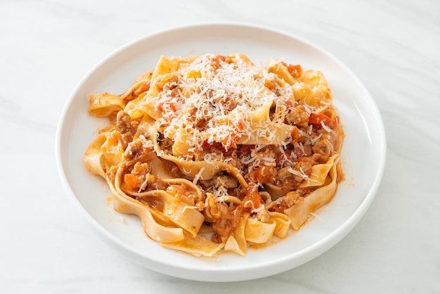 Homemade pasta fettuccine bolognese with cheese - Italian food style