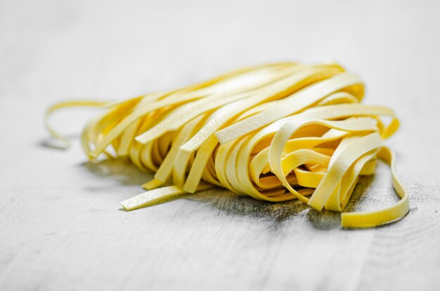 Photo homemade pasta tagliatelle on a white table