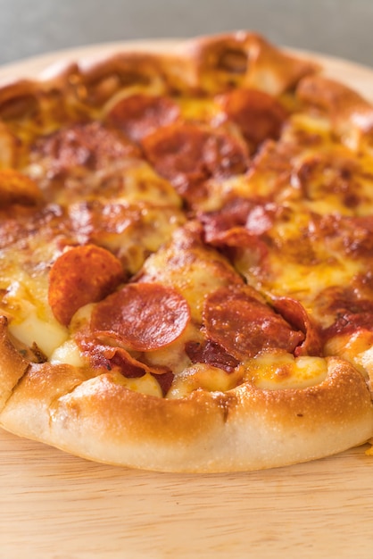 Homemade Pepperoni Pizza on wood plate