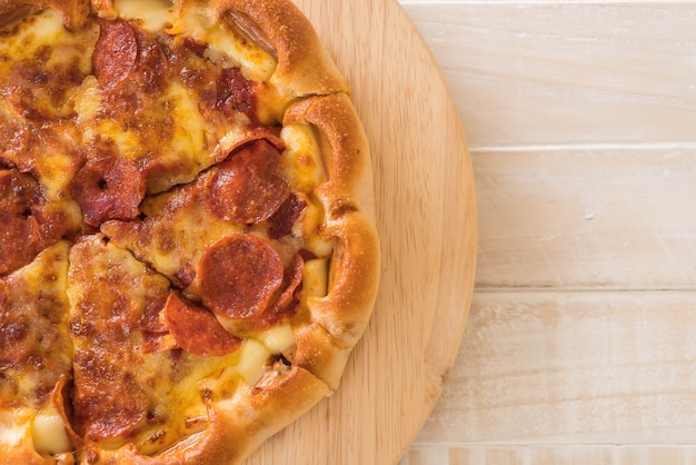 Homemade Pepperoni Pizza on wood plate