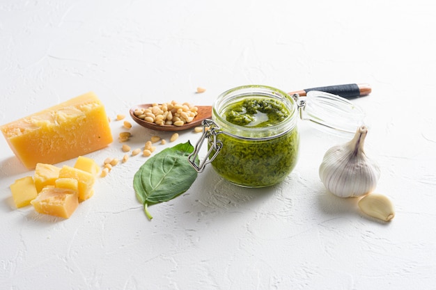 Homemade Pesto alla Genovese in glass jar with ingredients