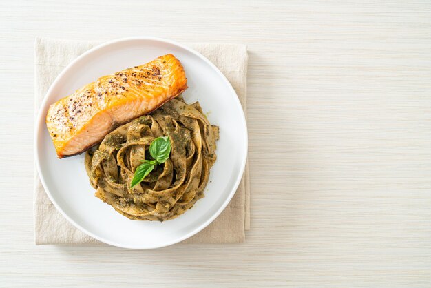 homemade pesto fettuccine spaghetti pasta with grilled salmon fillet