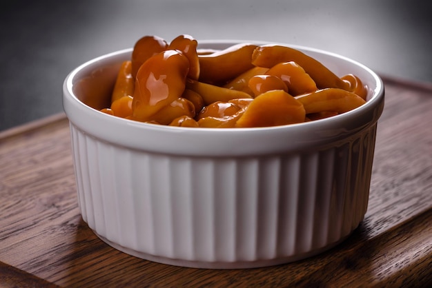 Homemade pickled honey agarics mushrooms in a white bowl