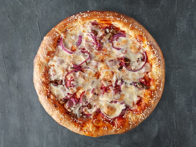 Homemade Pizza with hunting sausages, pickled red onions, mushrooms, mozzarella cheese and tomato sauce. Wide side. View from above. On a gray concrete background. Isolated.