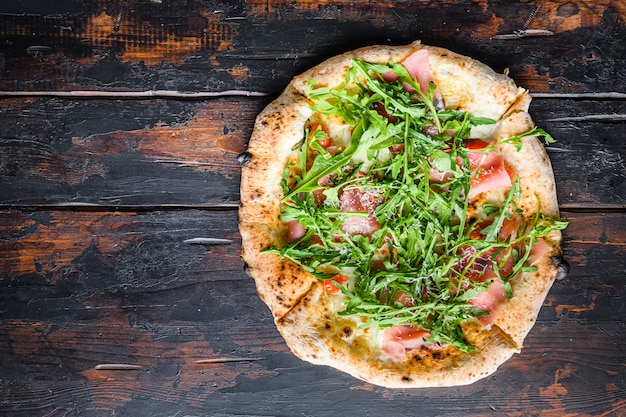 Homemade pizza with mozzarella, cheese and basil leaves