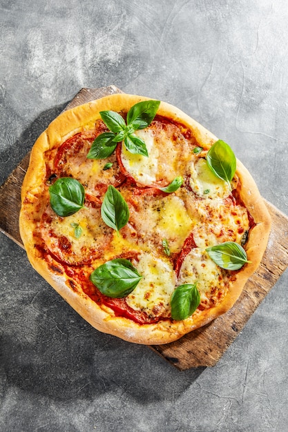 Homemade pizza with mozzarella on grey background