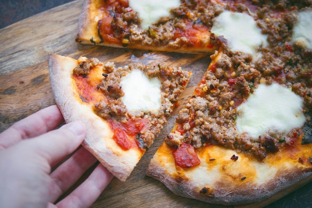 Homemade pizza, With mozzarella, tomatoes and meat, Dark back