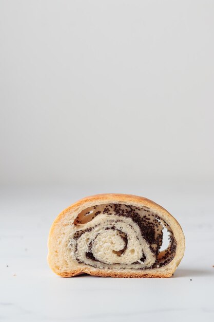 Homemade poppy seed roll buns on a white table