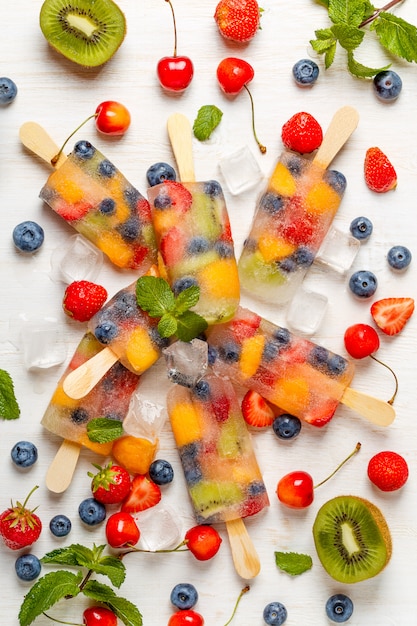 Homemade popsicles with berries and fruits.