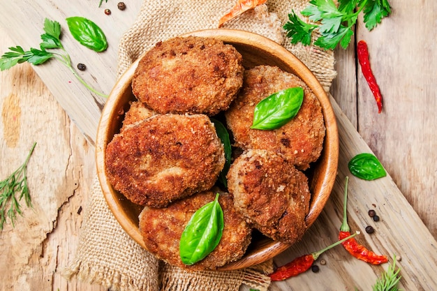 Homemade porkbeef cutlets or meatballs in a bowl rustic style vintage wooden background top view