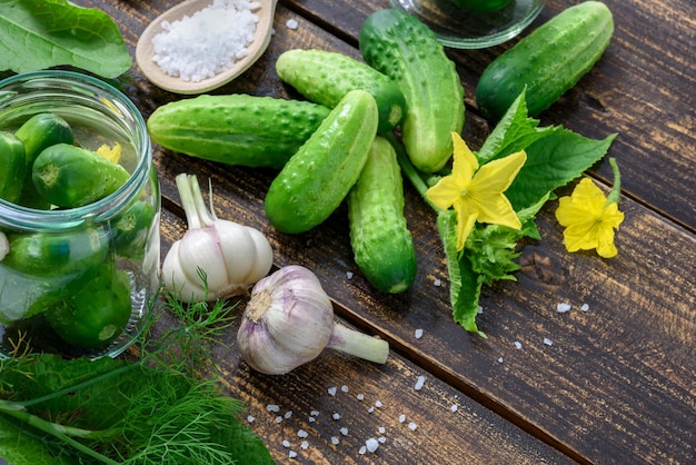 Homemade preserves jars of pickled cucumbers on a wooden table