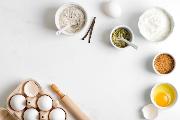 Homemade production of fresh healthy bread of other pastry from natural ingredients on a light grey table.