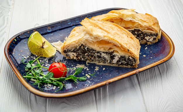 Homemade puff pastry pie with spinach and cheese