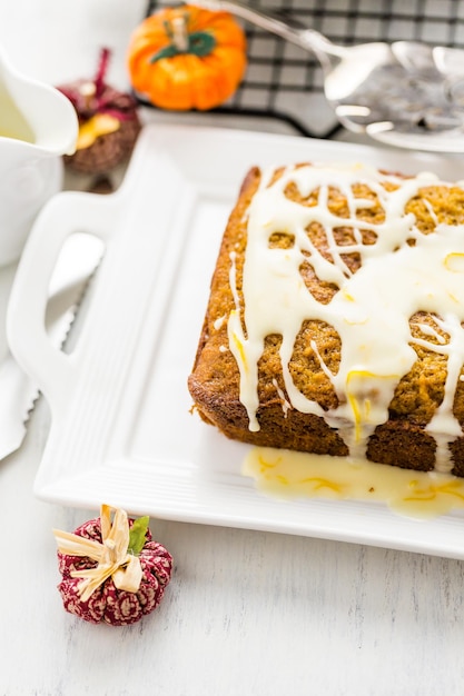 Homemade pumpkin bread with orange glazing on top.