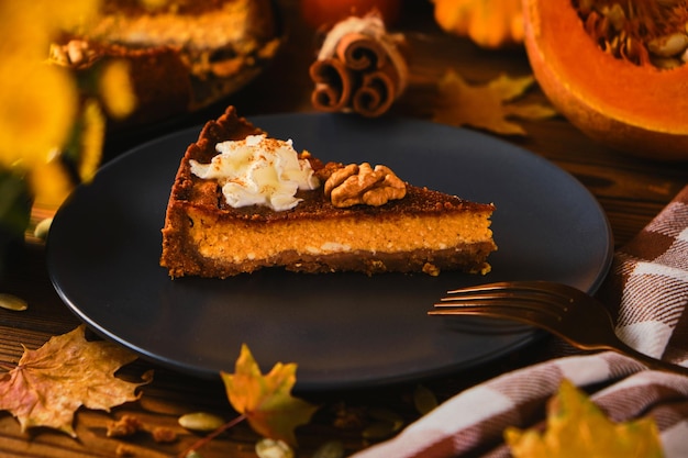 Homemade pumpkin cheesecake decorated with whipped cream