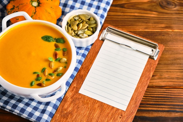 Homemade pumpkin soup with cream in a white bouillon dish