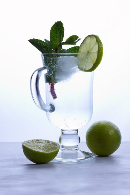 Homemade refreshing lemonade with slices of organic ripe lime Fresh healthy cold lime beverage Water with lime Closeup