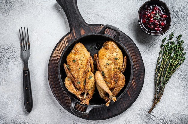 Homemade roast quail in a pan