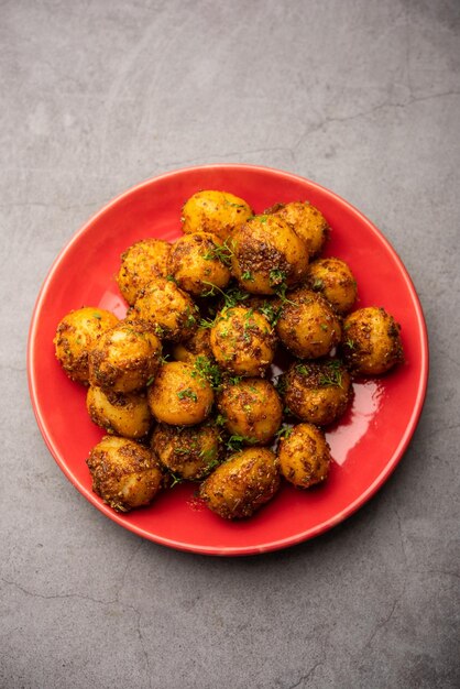 Homemade Roasted Bombay potatoes Pan fried little baby potatoes or aloo with jeera seeds and coriander in bowl