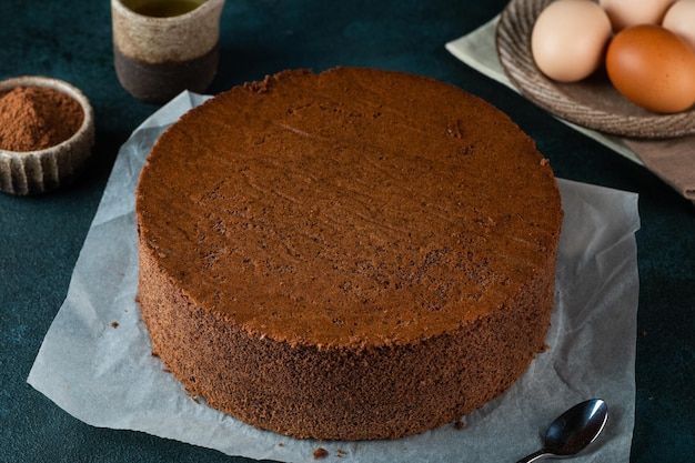 Homemade round chocolate sponge cake or chiffon cake Sponge cake ingredients eggs flour and cocoa Chocolate biscuit