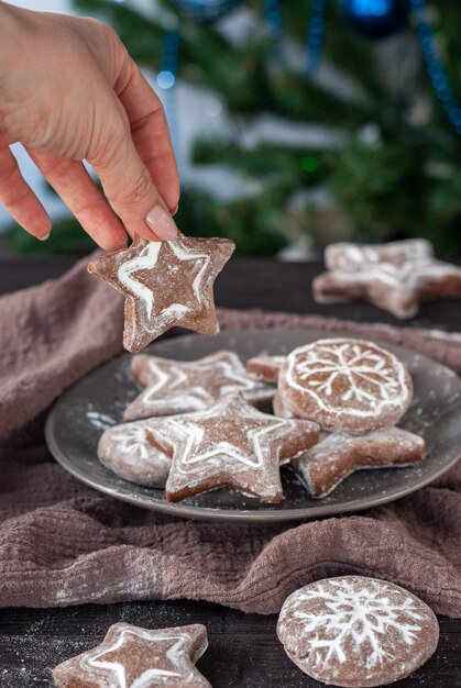 Homemade round and star shaped christmas gingerbreads on a dark napkin