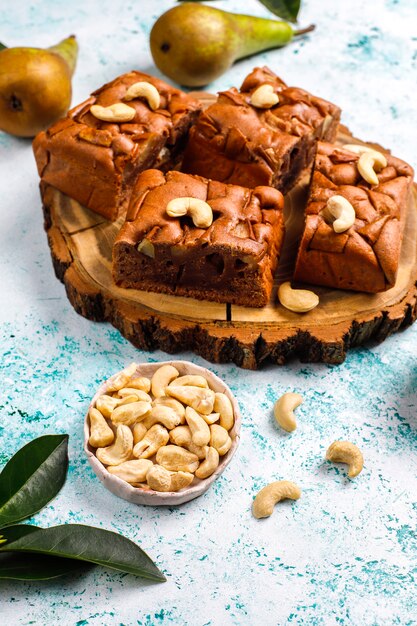 Homemade rustic chocolate cake with pear and cashew nuts