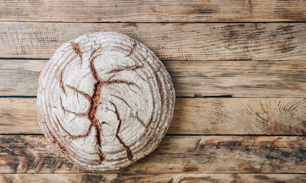 Homemade rye bread on rustic wooden background