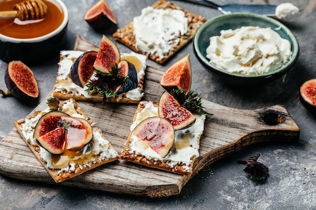 Homemade sandwiches wholemeal cookies with creamcheese and fresh figs Keto diet Keto snack Food recipe background Close up