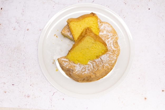 Homemade Savoie cake on a pretty white porcelain dish