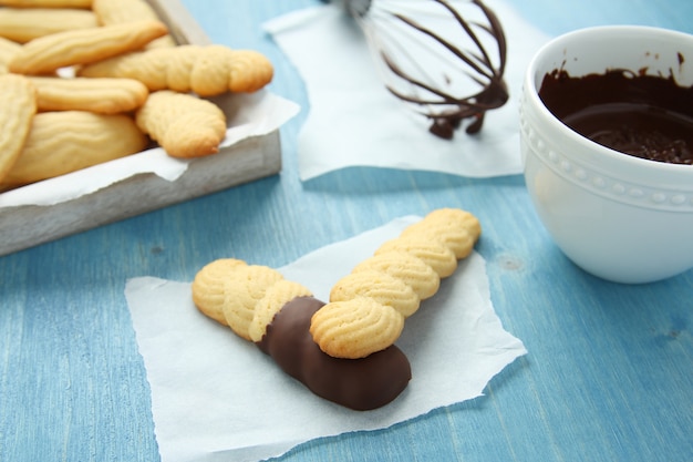 Homemade shortbread cookies with chocolate on blue wooden background