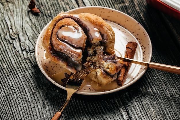 Homemade Sinnabon buns with cinnamon and white cream sauce. sweet traditional dessert buns