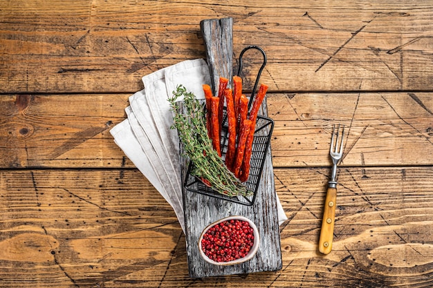 Homemade small thin kabanos sausages in a basket Wooden background Top view