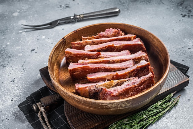 Homemade Smoked Barbecue Pork Ribs in wooden plate ready for eat Gray background Top view