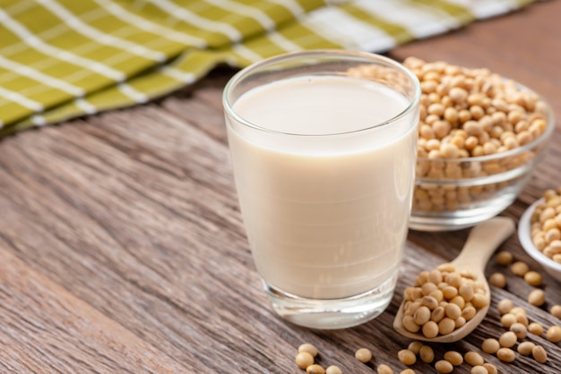 Homemade Soy milk and Soybean on wooden background, Healthy drink.