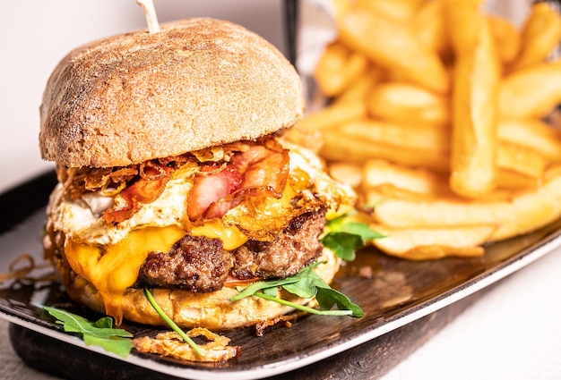 Homemade spicy hot cheeseburger with grilled beef cheese and lettuce leaf between burger buns side view restaurant concept