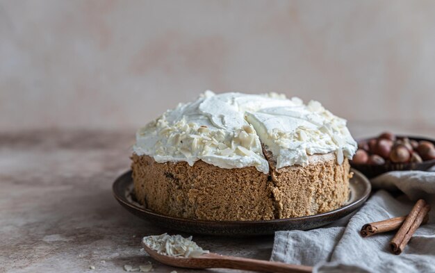 Homemade sponge cake or biscuit with nuts and spices with butter cream or cream cheese icing.