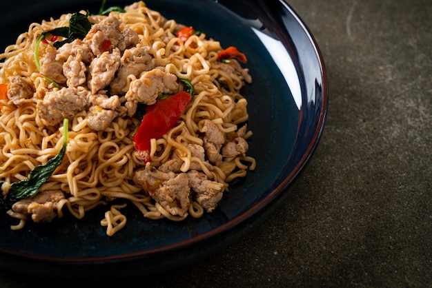 homemade stir-fried instant noodles with Thai basil and minced pork - Thai food style