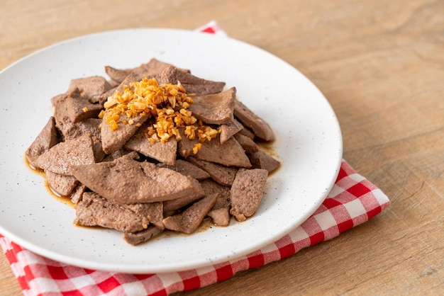 homemade stir-fried pork liver with garlic on plate